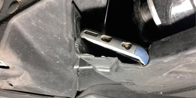 cell phone hidden in a gap of the undercarriage of vehicle used as a GPS tracker